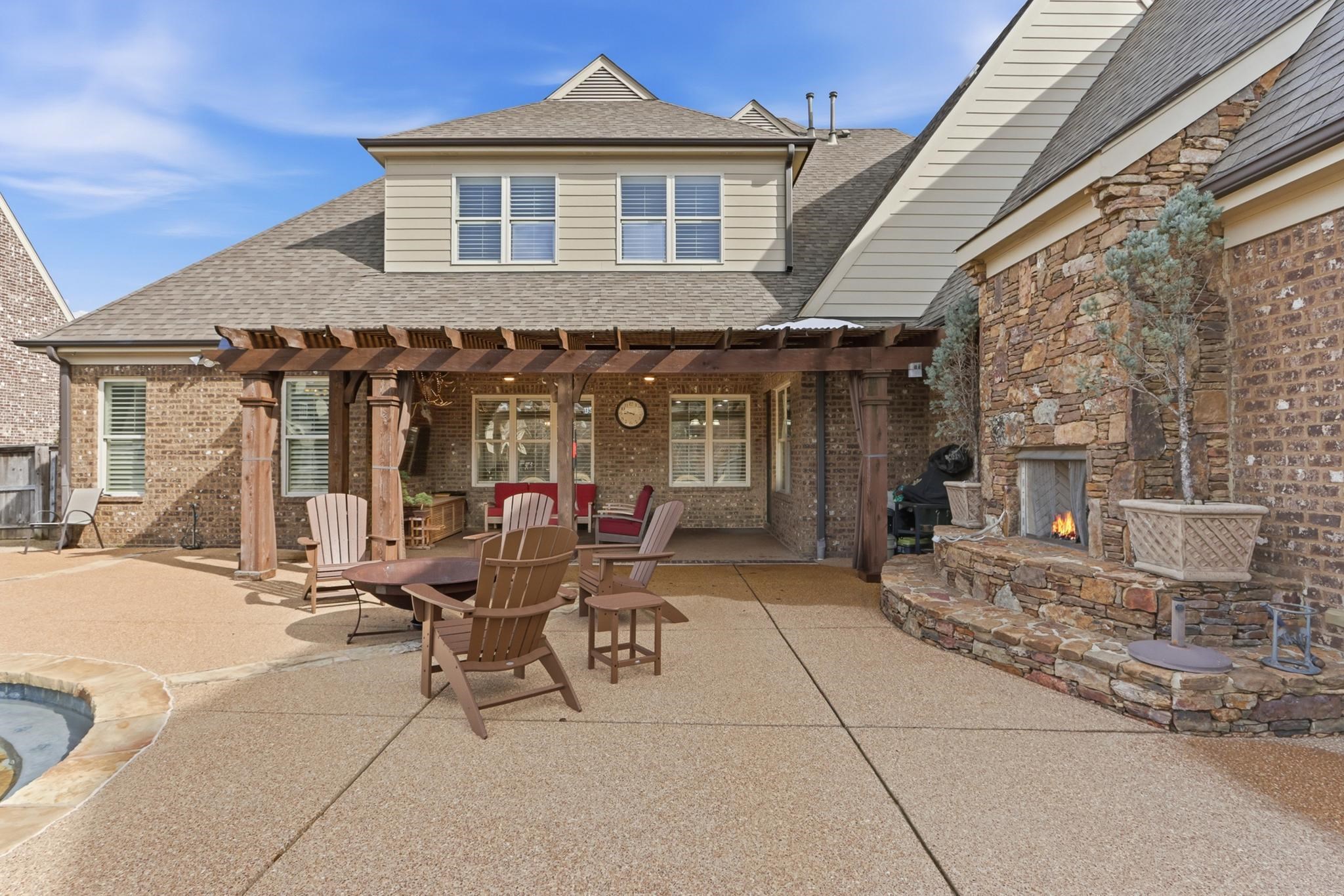 1301 Conser Street Collierville, TN 38017 - Photo 30 of 40 a patio with a table and chairs and potted plants