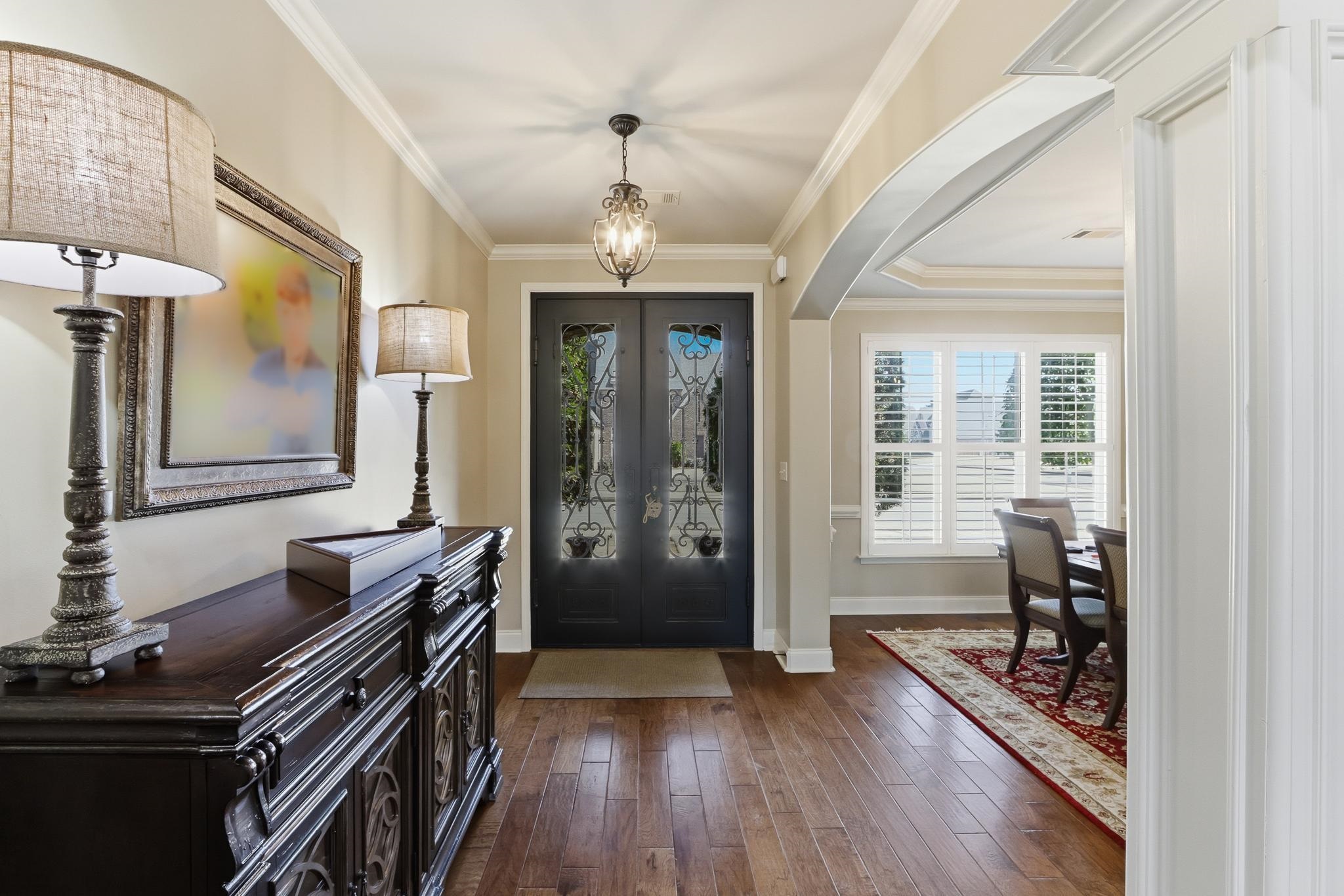 1301 Conser Street Collierville, TN 38017 - Photo 5 of 40 a hallway with wooden floor and staircase
