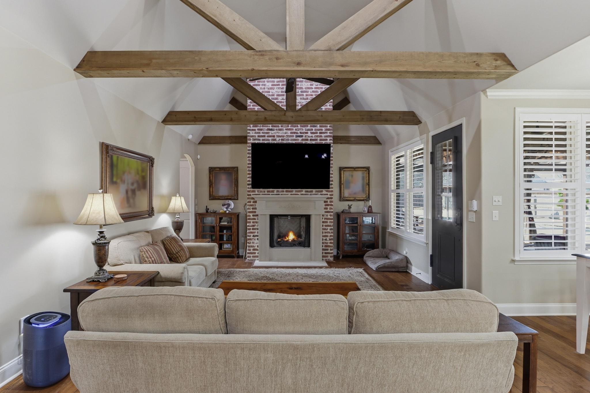 1301 Conser Street Collierville, TN 38017 - Photo 8 of 40 a living room with furniture a fireplace and a flat screen tv