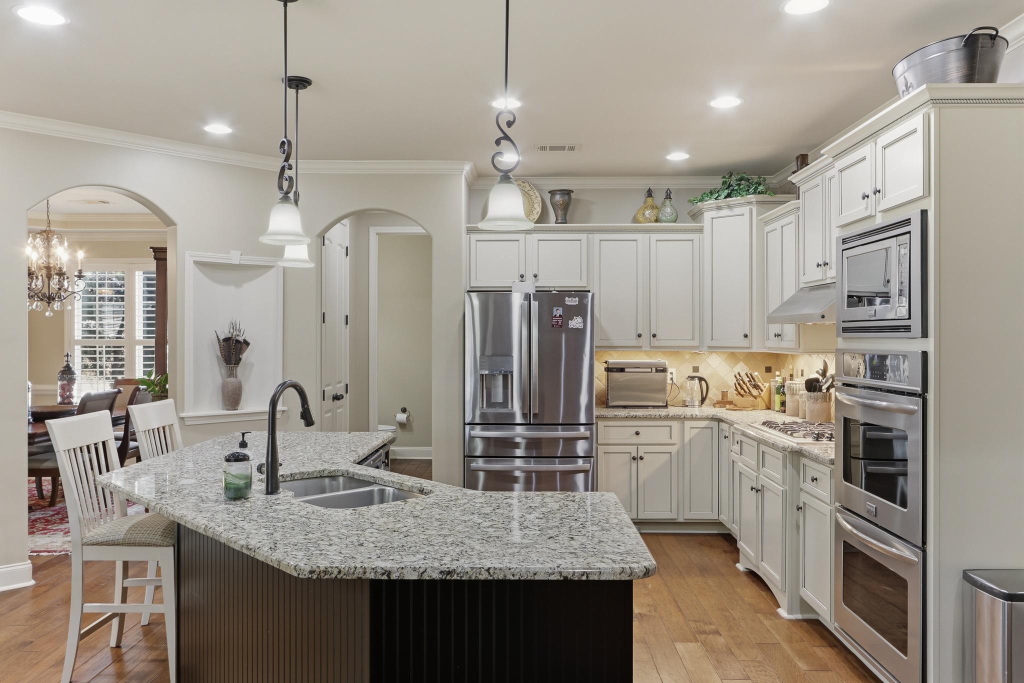 1301 Conser Street Collierville, TN 38017 - Photo 10 of 40 a kitchen with stainless steel appliances granite countertop a sink refrigerator and cabinets