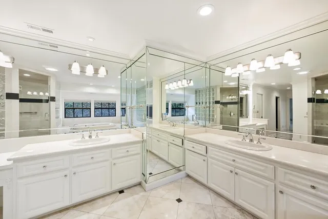 a kitchen with granite countertop white cabinets and a wooden floor