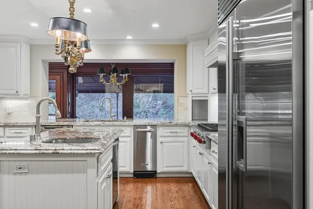 a view of a patio with couches and a table and chairs with garden view