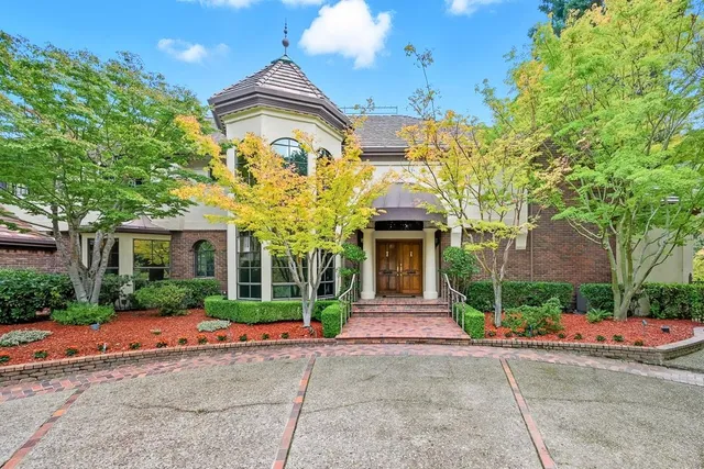 a front view of a house with a garden