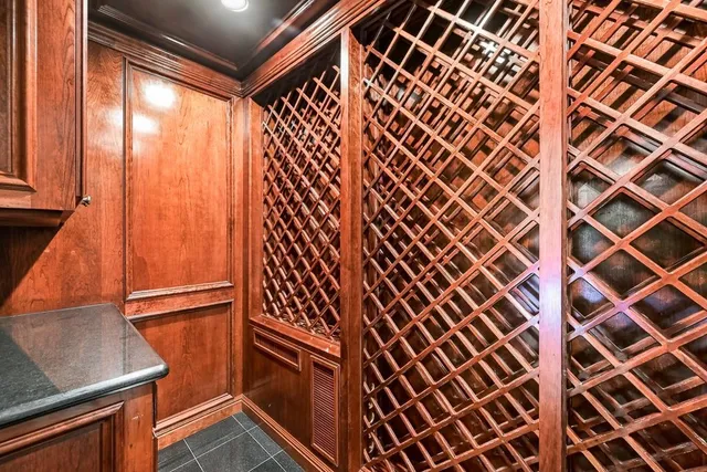 a living room with furniture a fireplace and a floor to ceiling window