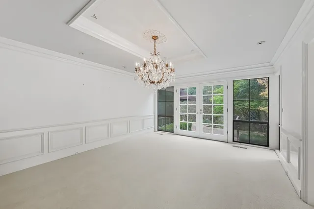 a view of a big room with wooden floor and windows