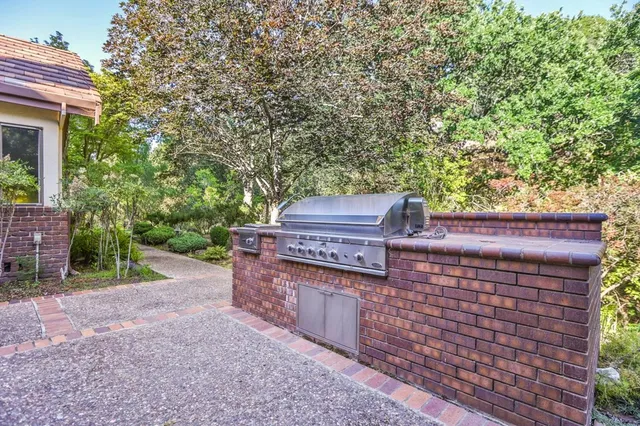 a bathroom with a granite countertop sink toilet a mirror a vanity and shower