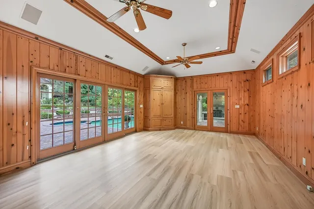 a view of a brick house with large windows