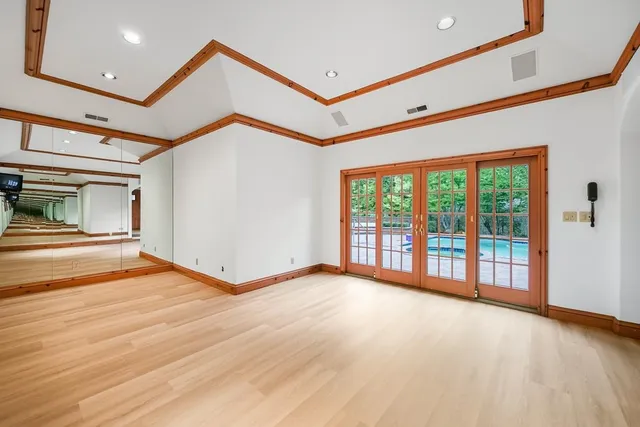 a kitchen with granite countertop a sink window and cabinets