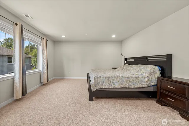 a bedroom with a bed and a cabinets