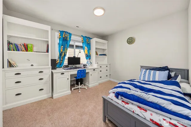 a bedroom with a bed and a book shelf