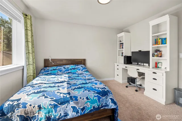 a bedroom with a bed and flat screen tv