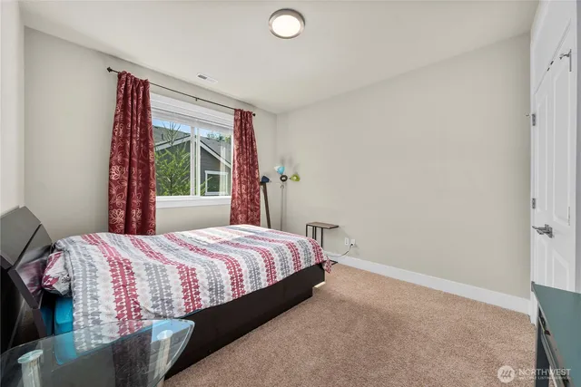 a bedroom with a bed and window