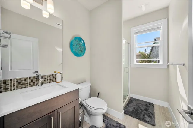 a bathroom with a sink a toilet a mirror and vanity