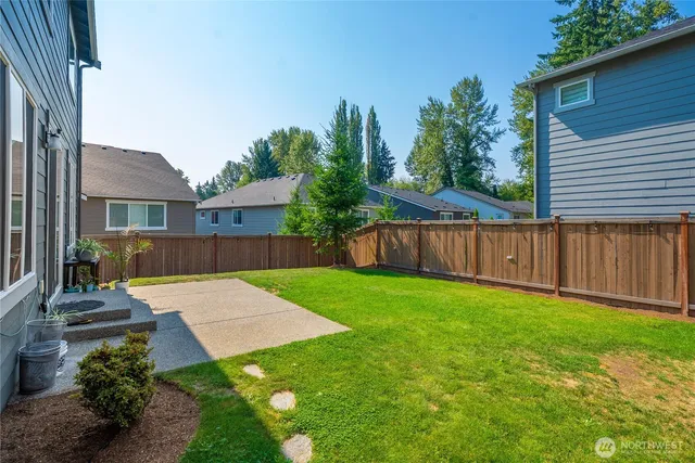 a view of a house with backyard and sitting area