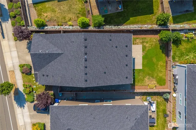an aerial view of a house with a yard