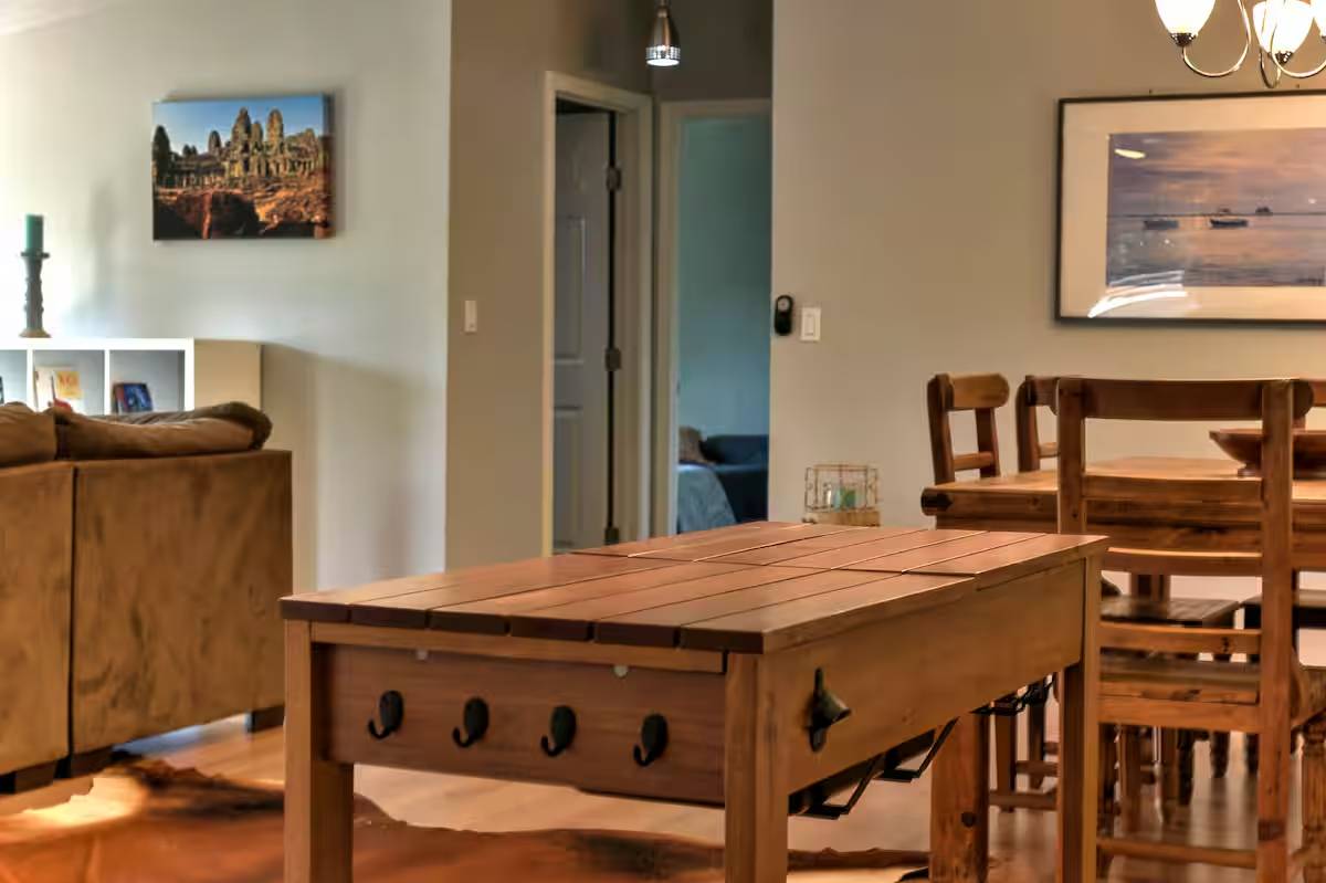 8807 High Valley Road Austin, TX 78737 - Photo 4 of 22 A well-appointed living and dining area boasts rich hardwood flooring, creating an inviting atmosphere.