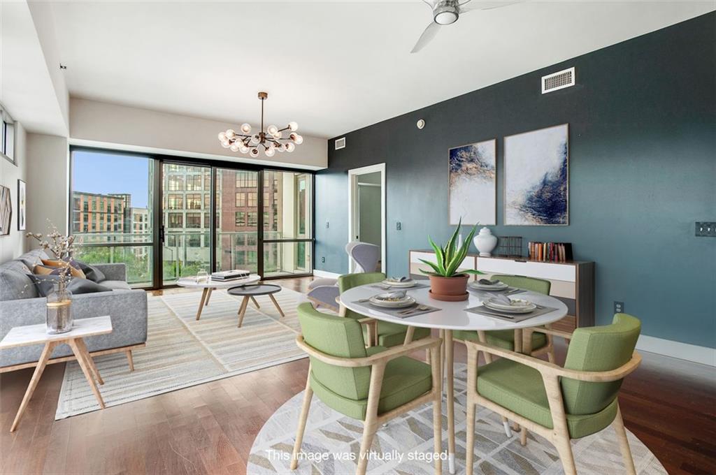 a dining room with furniture a chandelier and wooden floor
