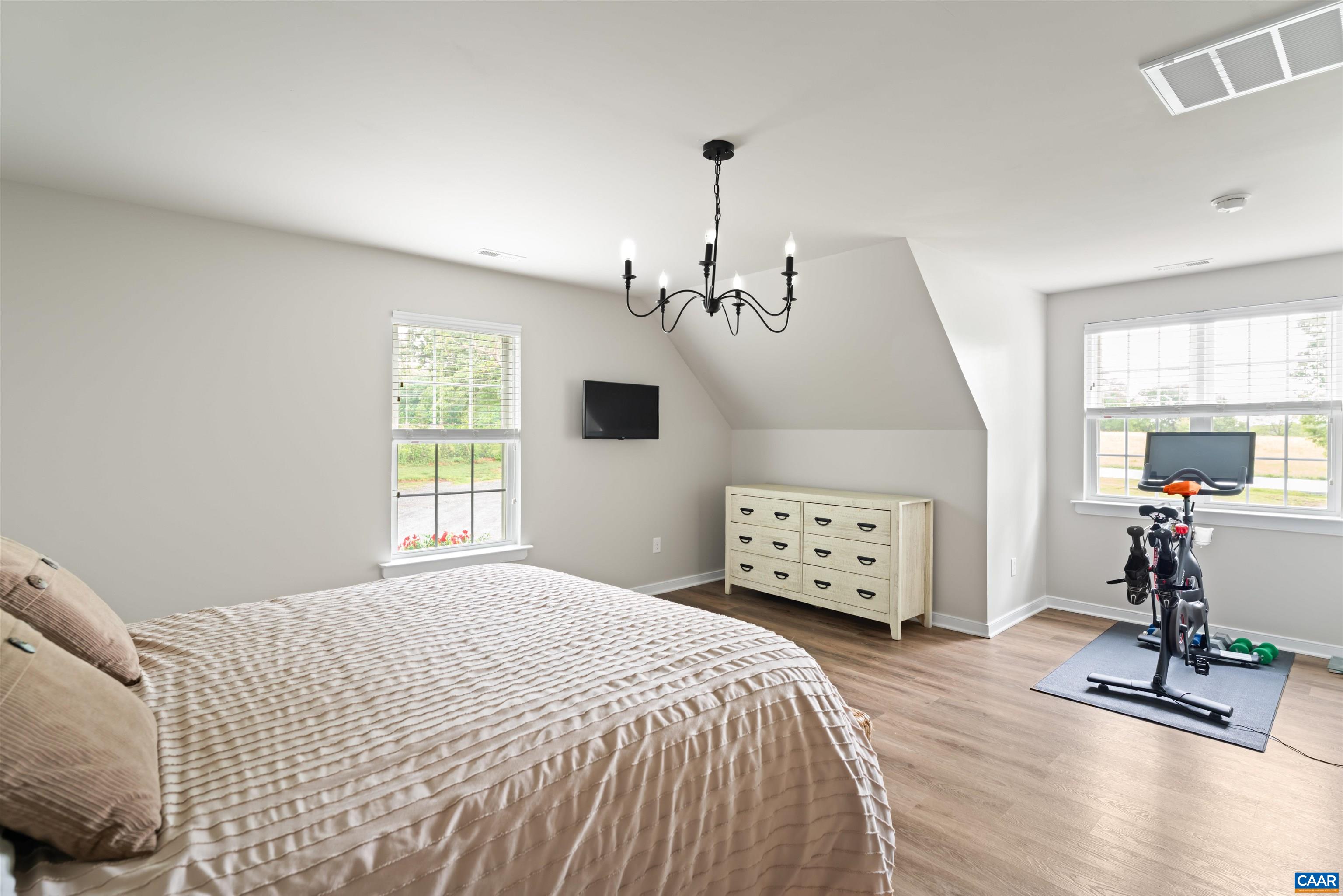1760 Haden Martin Road Palmyra, VA 22963 - Photo 30 of 51 a bedroom with a bed chandelier and a window