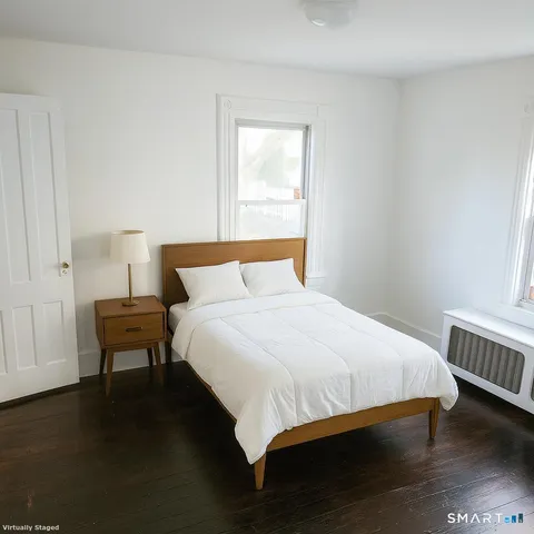 a bedroom with a bed and a window