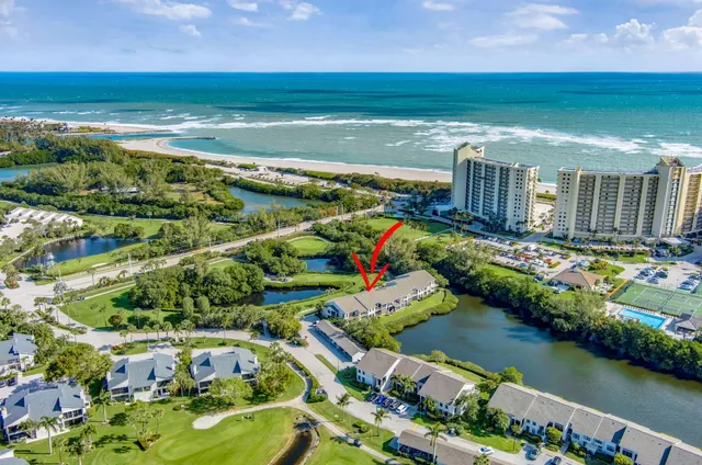 a view of a swimming pool with a patio and a yard