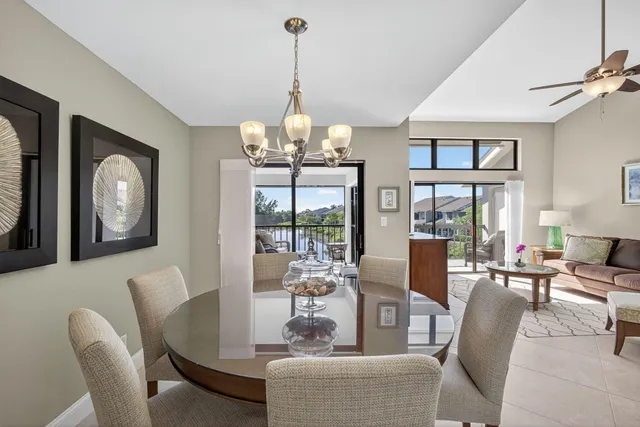 a living room with furniture a chandelier and a flat screen tv