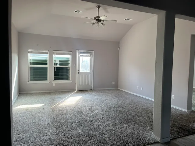 a view of a livingroom with a ceiling fan and window
