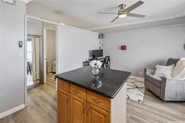 a view of kitchen island with furniture and wooden floor