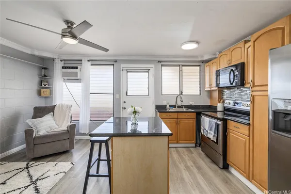 a kitchen with sink refrigerator and microwave