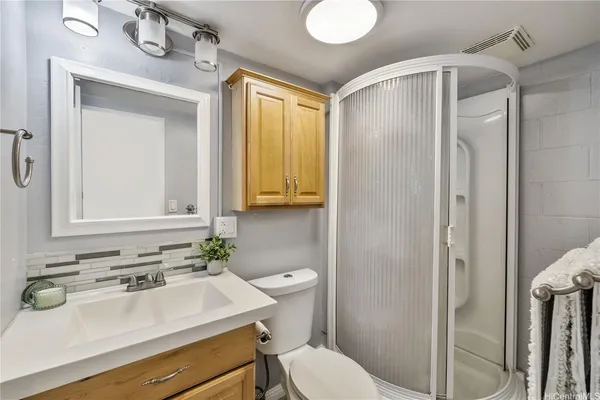 a bathroom with a sink toilet and mirror