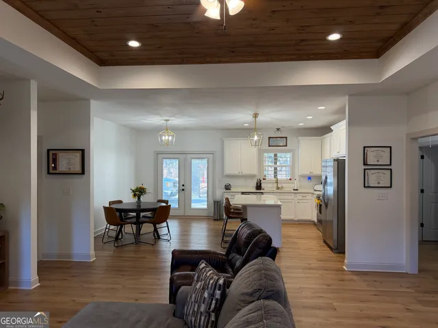 a living room with furniture and view of kitchen