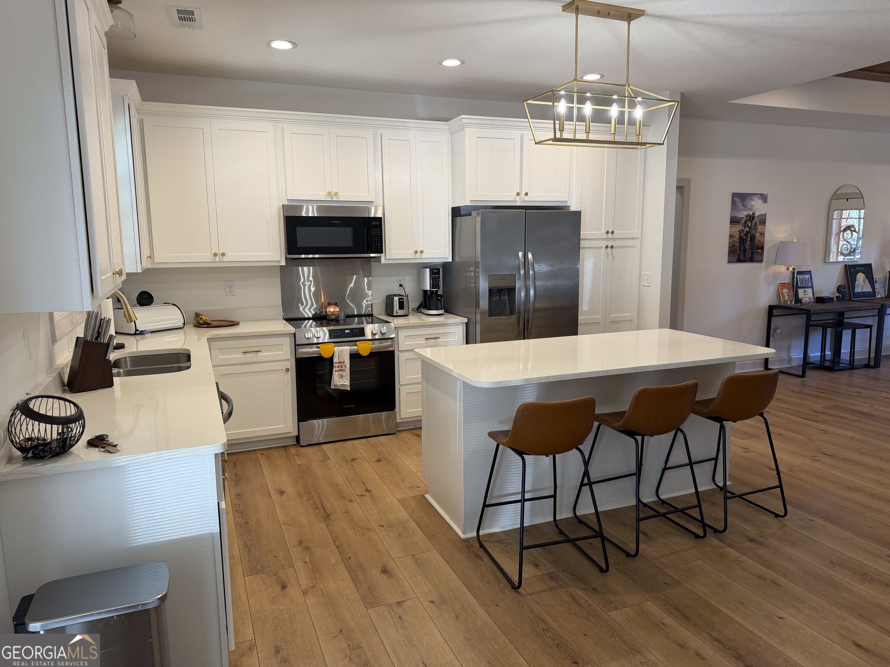 1347 Payne Road Rentz, GA 31075 - Photo 18 of 45 a kitchen with stainless steel appliances wooden floor dining table and chairs