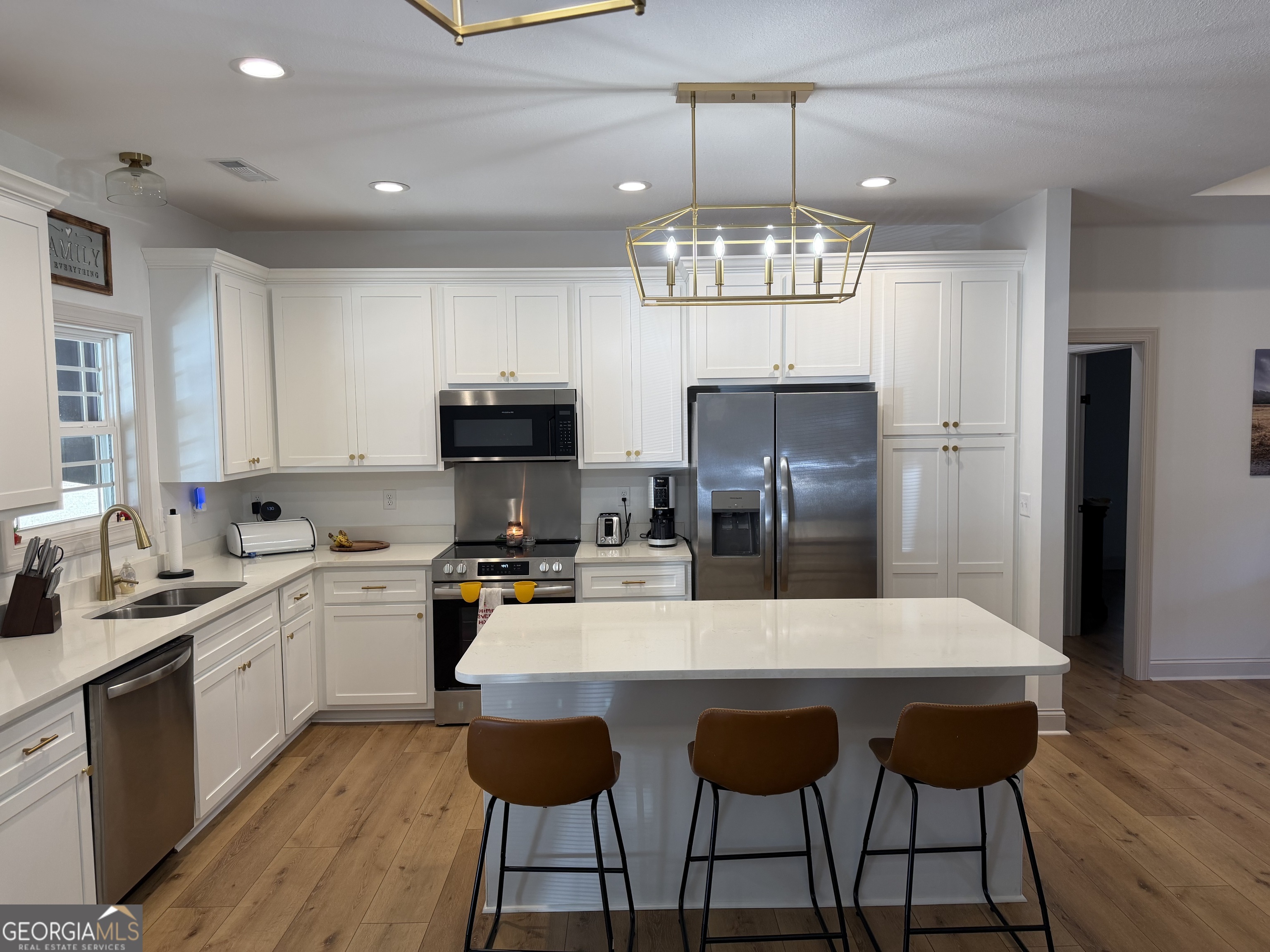 1347 Payne Road Rentz, GA 31075 - Photo 20 of 45 a kitchen with stainless steel appliances a dining table chairs sink and refrigerator