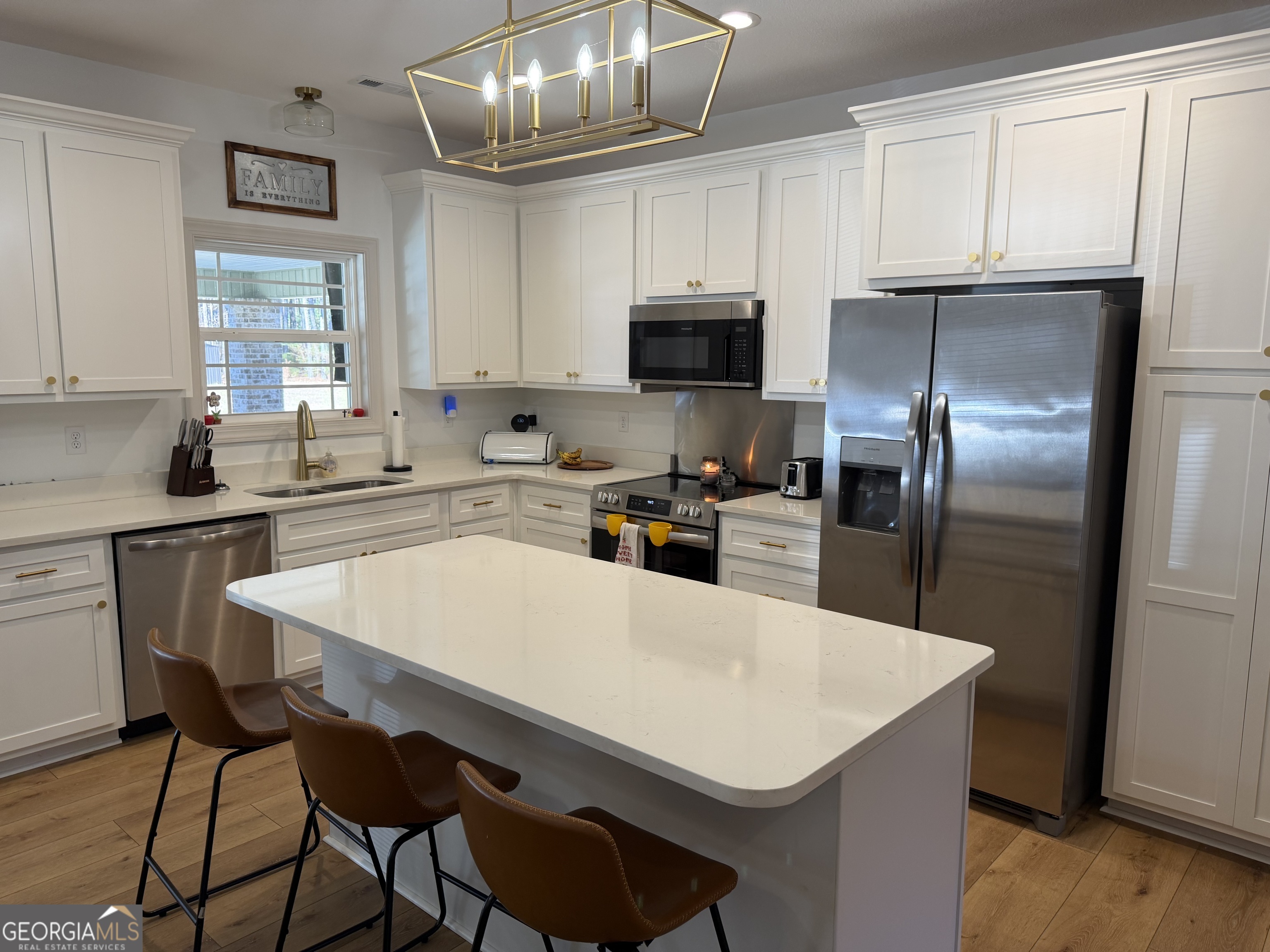 1347 Payne Road Rentz, GA 31075 - Photo 23 of 45 a kitchen with a sink a kitchen island and stainless steel appliances