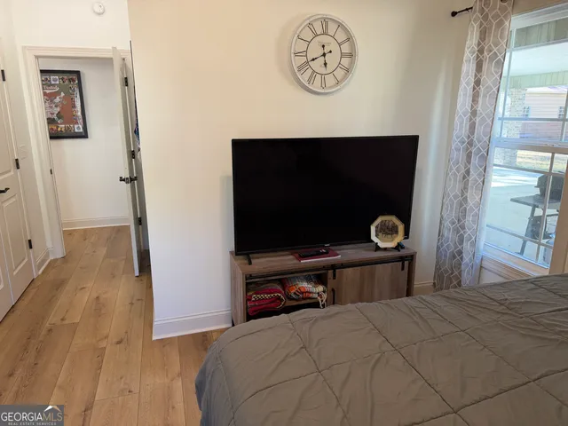 a bedroom with furniture and wooden floor