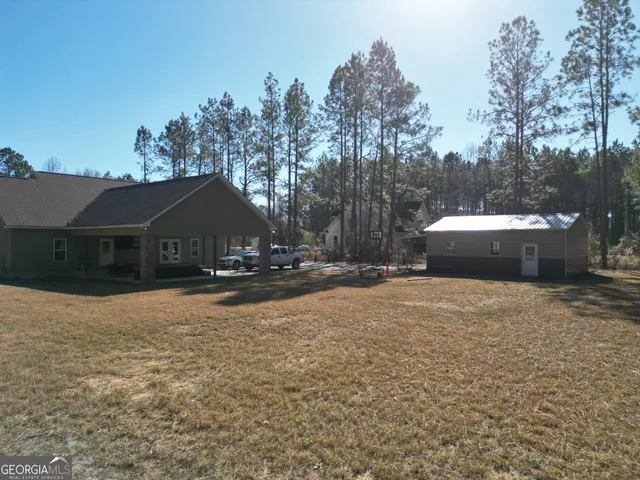 a house view with a sitting space and garden