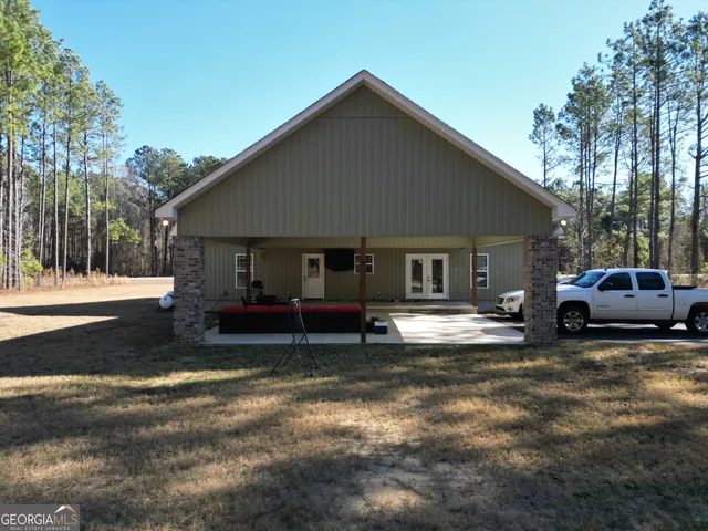 a view of backyard with swimming pool and sitting area