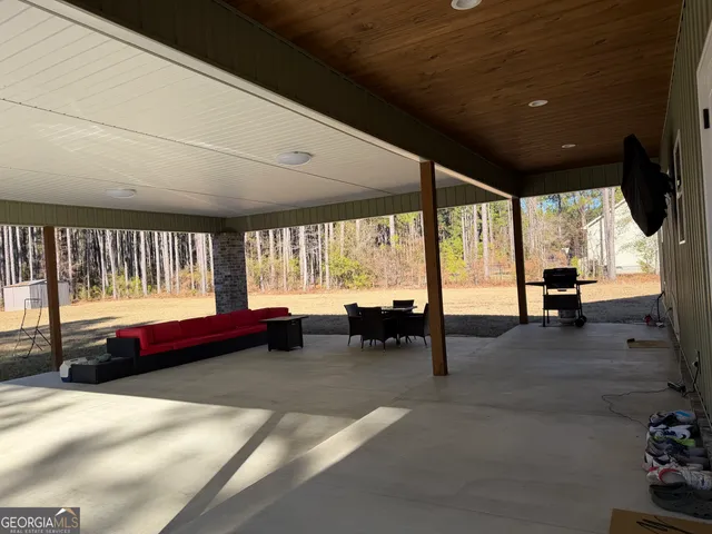 a living room with furniture gym equipment and a large window