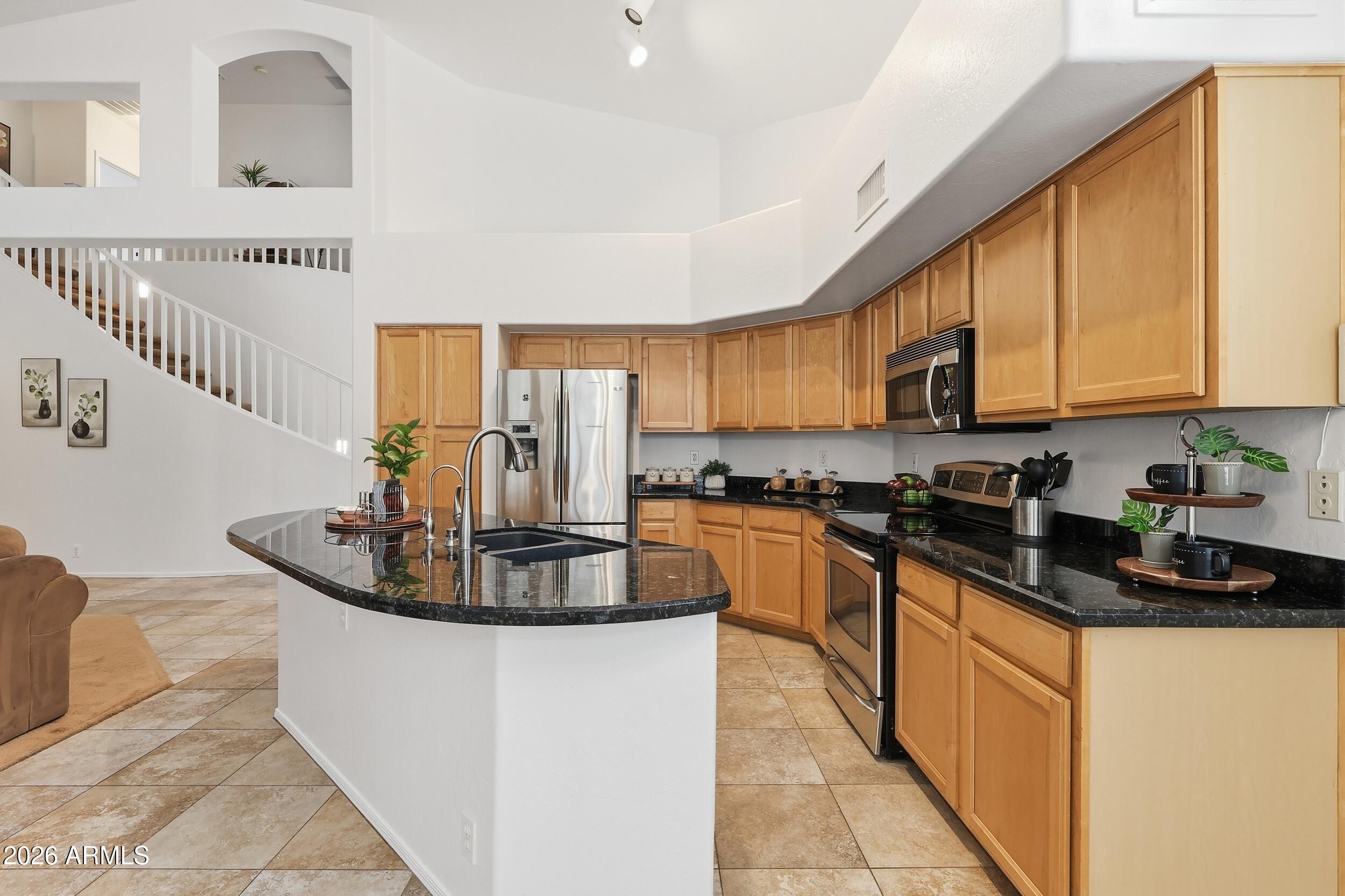 5377 West Jupiter Way Chandler, AZ 85226 - Photo 12 of 49 a kitchen with stainless steel appliances granite countertop a sink and cabinets