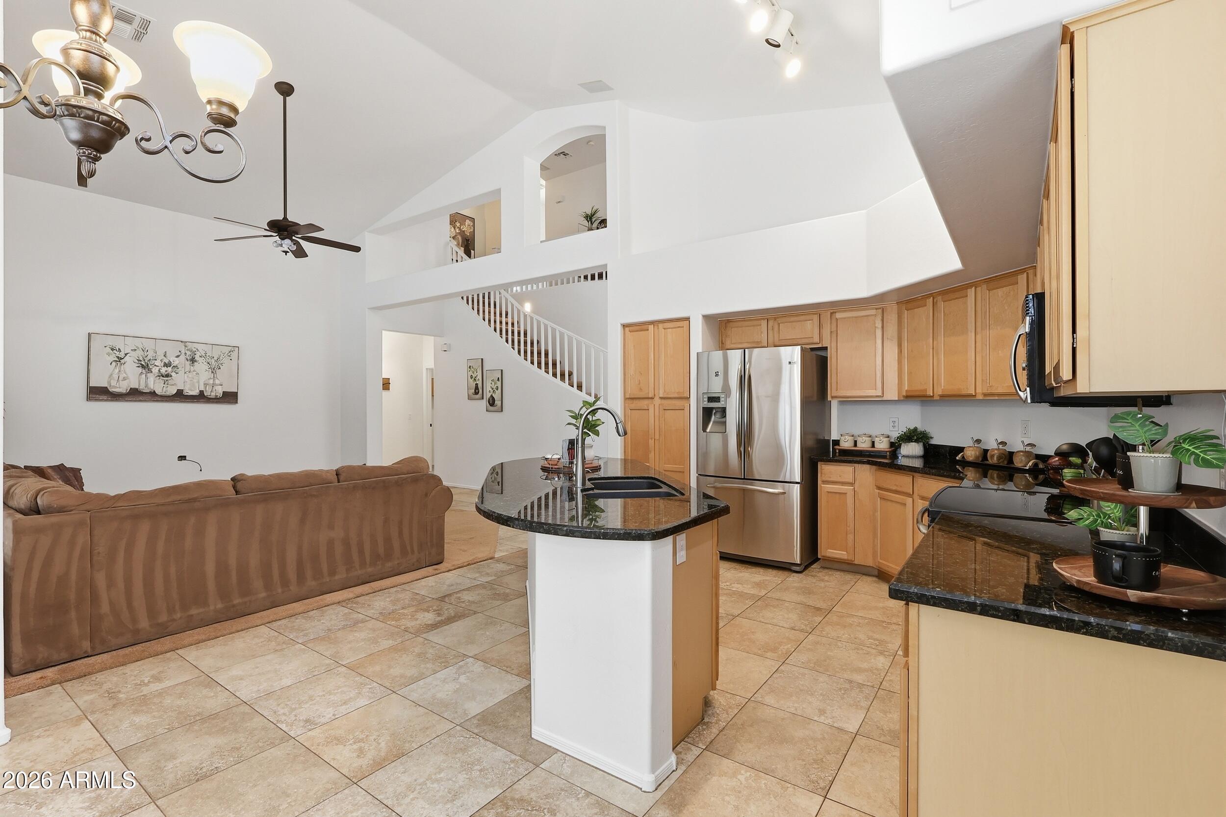 5377 West Jupiter Way Chandler, AZ 85226 - Photo 13 of 49 a kitchen with a stove a refrigerator and chairs