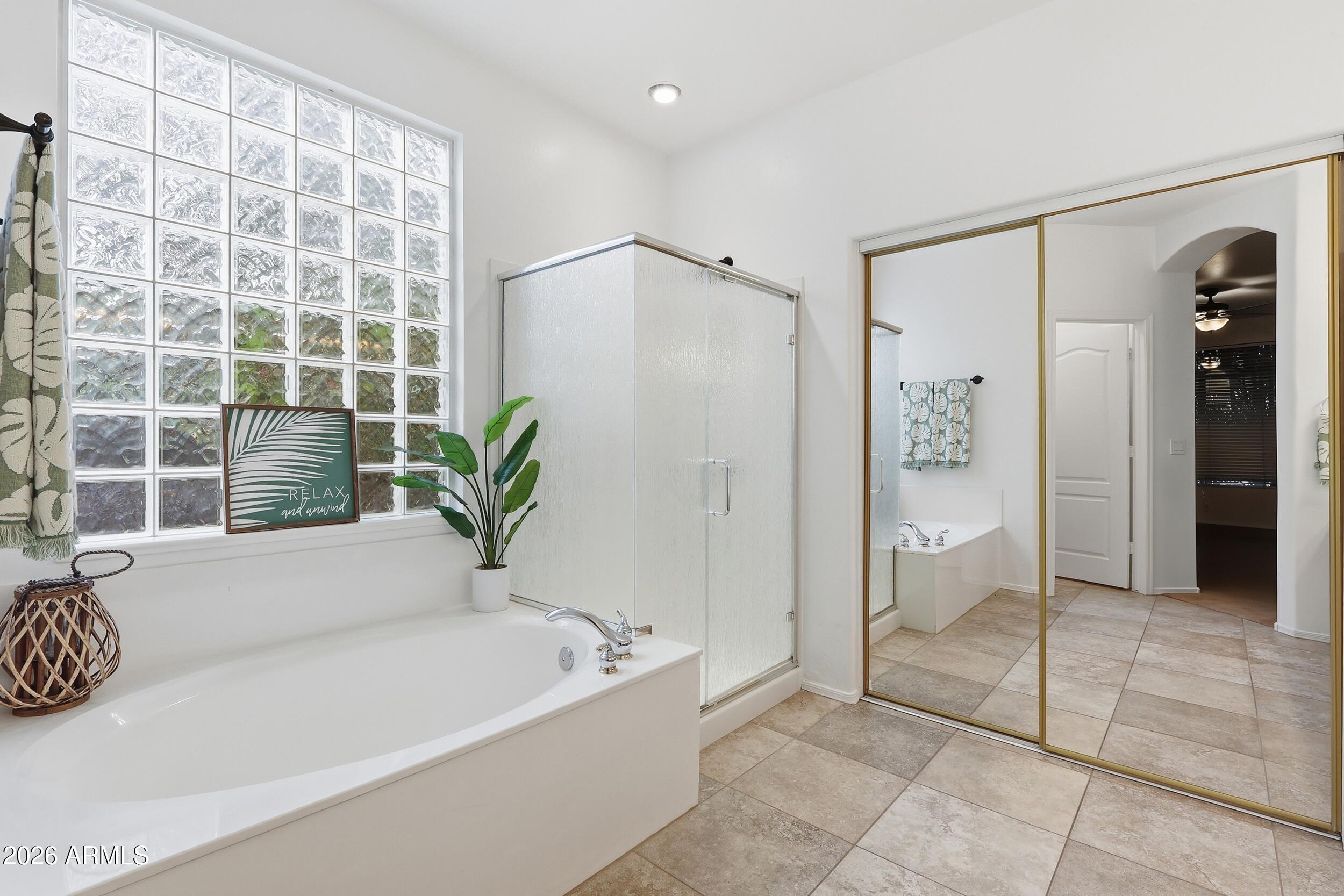 5377 West Jupiter Way Chandler, AZ 85226 - Photo 22 of 49 a bathroom with a bathtub and a shower