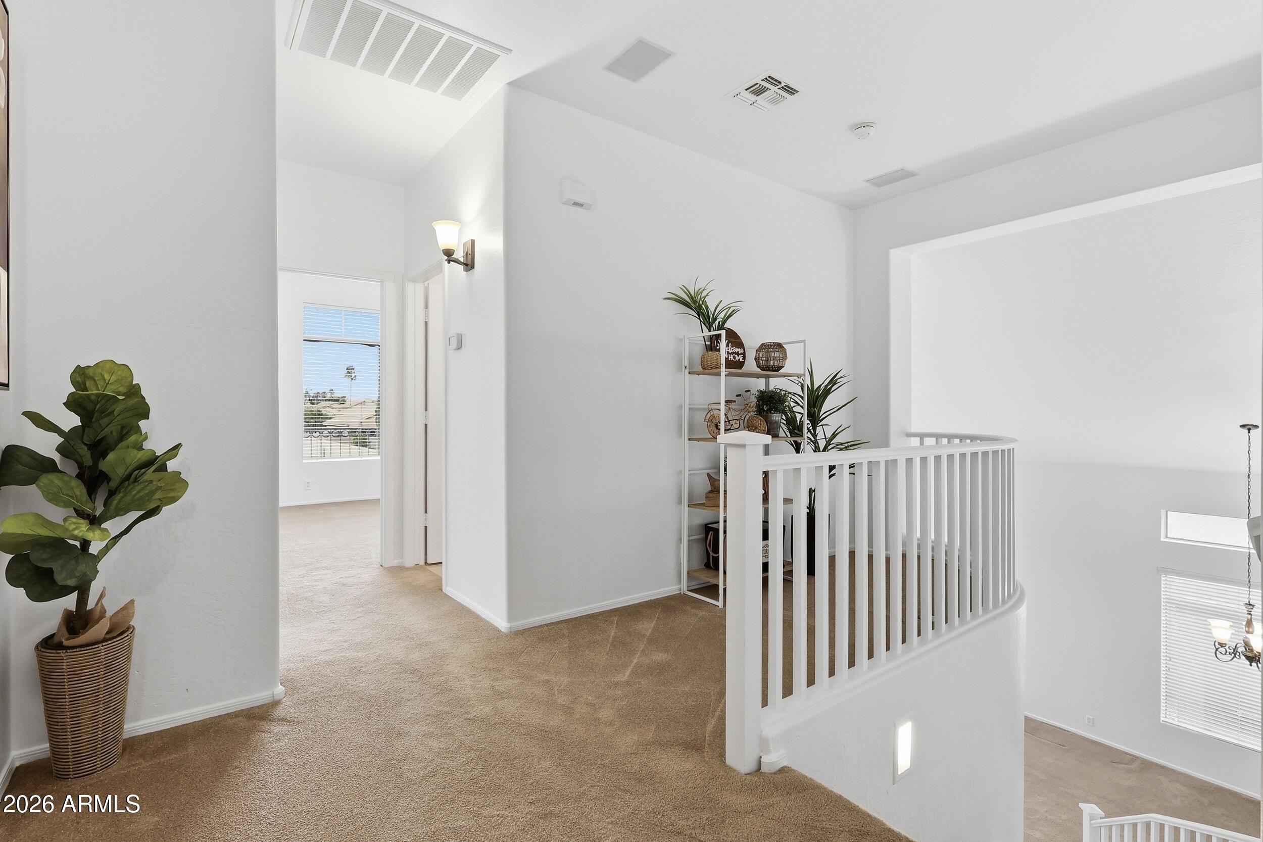 5377 West Jupiter Way Chandler, AZ 85226 - Photo 25 of 49 a view of a hallway to a livingroom with a potted plant