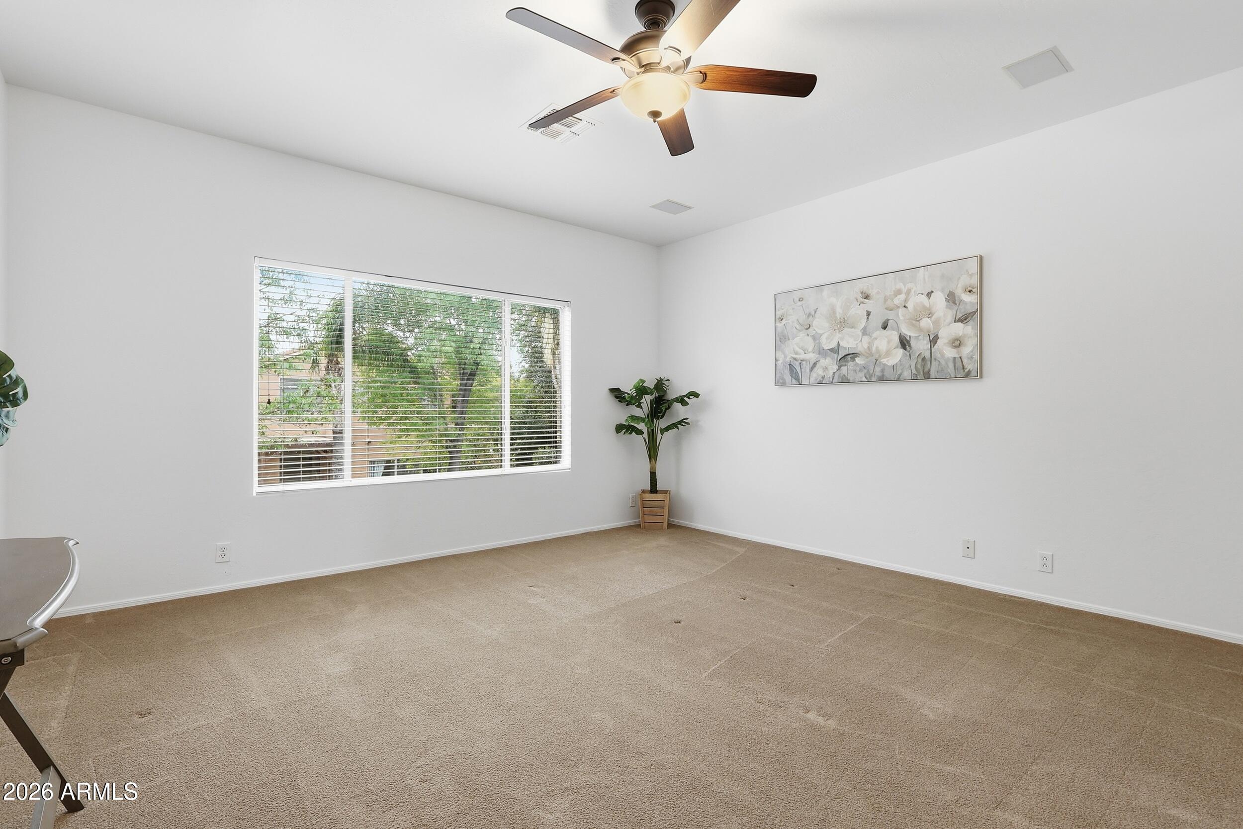 5377 West Jupiter Way Chandler, AZ 85226 - Photo 26 of 49 a view of a big room with windows and chandelier fan