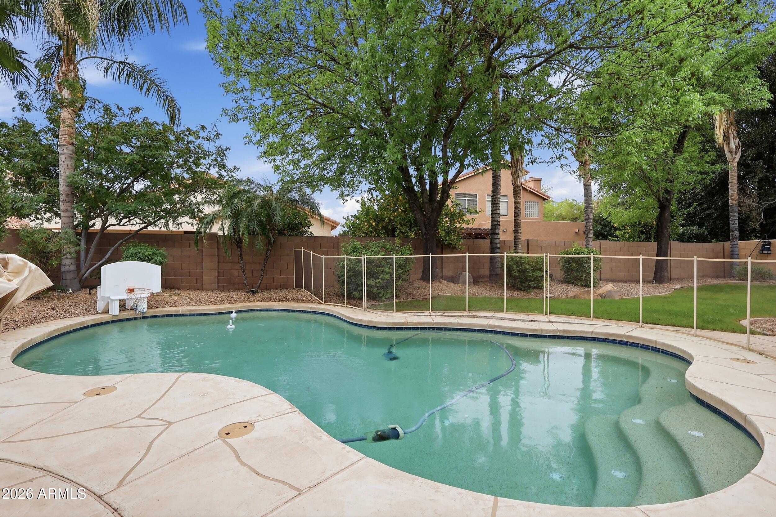 5377 West Jupiter Way Chandler, AZ 85226 - Photo 36 of 49 a view of a swimming pool with a patio and a yard