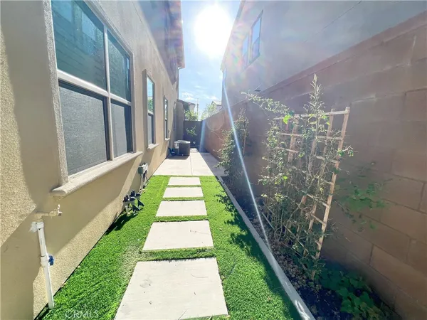 a view of a backyard with white walls