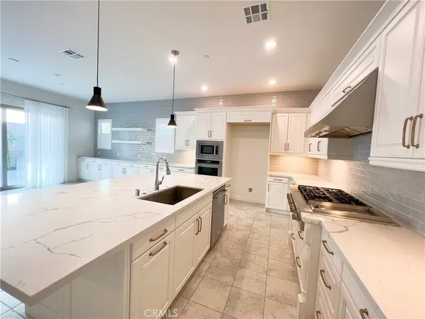 a kitchen with stainless steel appliances granite countertop a sink and cabinets