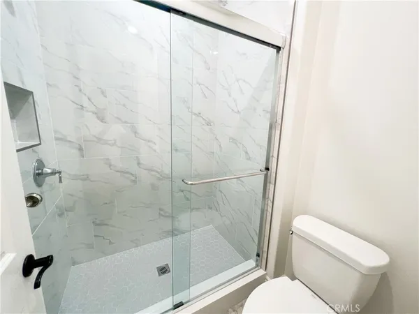 a bathroom with a shower and toilet