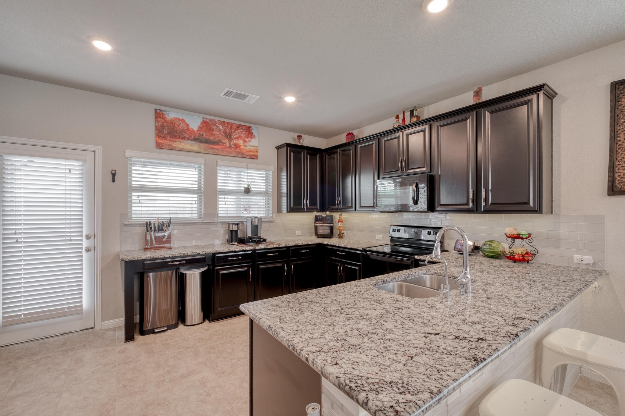19028 Quebrada Drive Pflugerville, TX 78660 - Photo 12 of 36 a kitchen with stainless steel appliances granite countertop sink stove and refrigerator