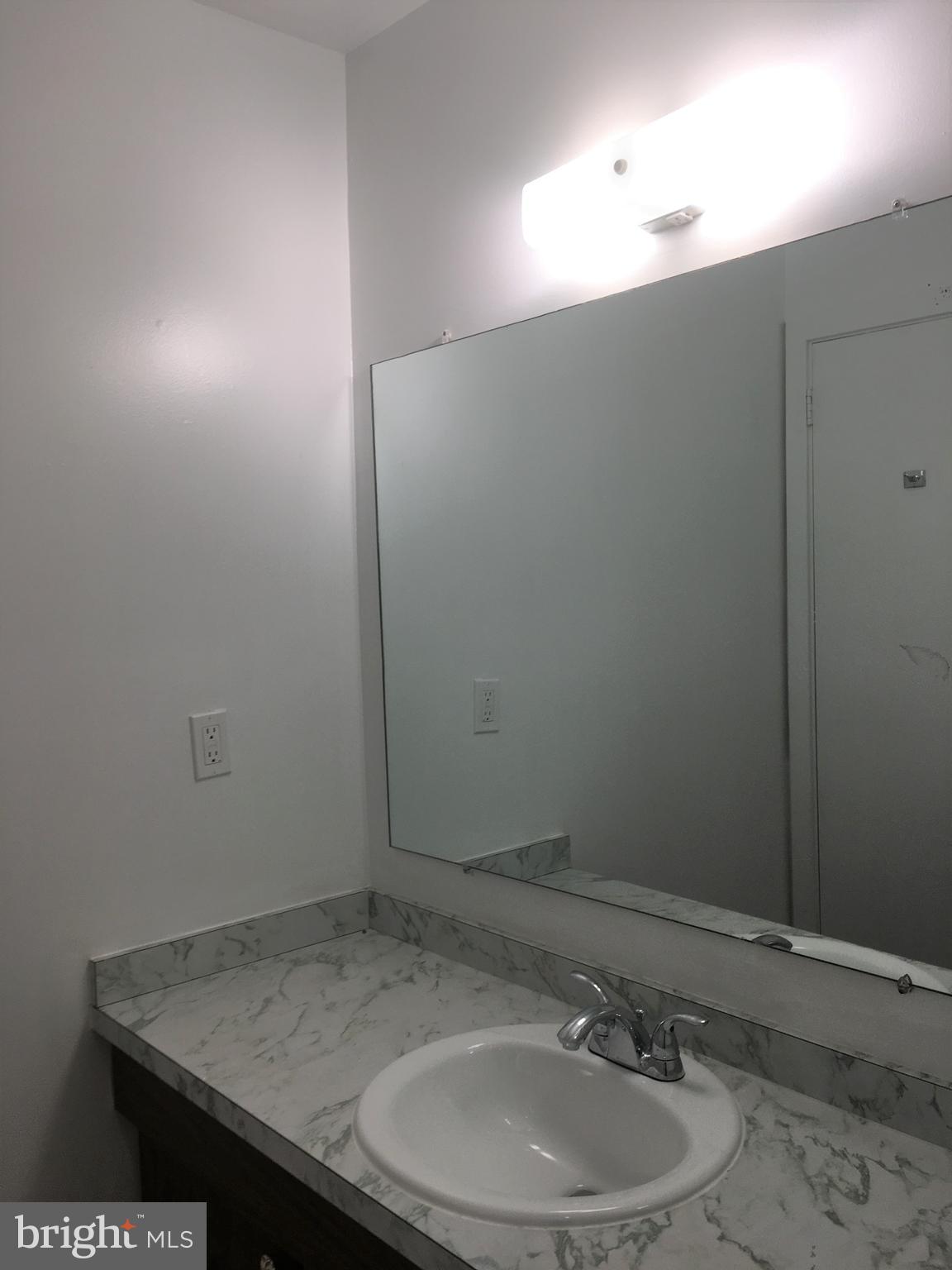 10343 Tailcoat Way Columbia, MD 21044 - Photo 12 of 21 a bathroom with a sink and a mirror