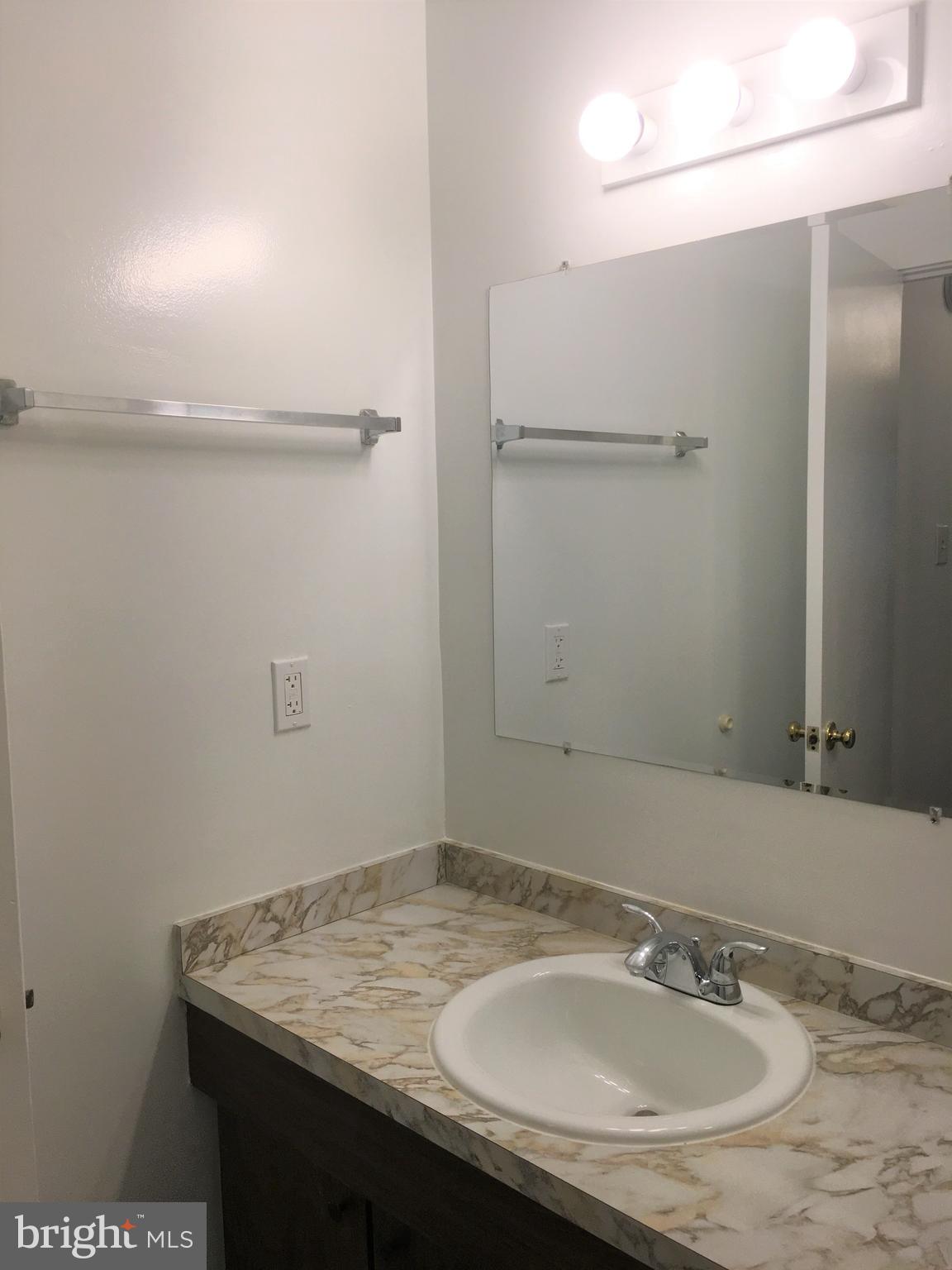 10343 Tailcoat Way Columbia, MD 21044 - Photo 17 of 21 a bathroom with a sink and a mirror