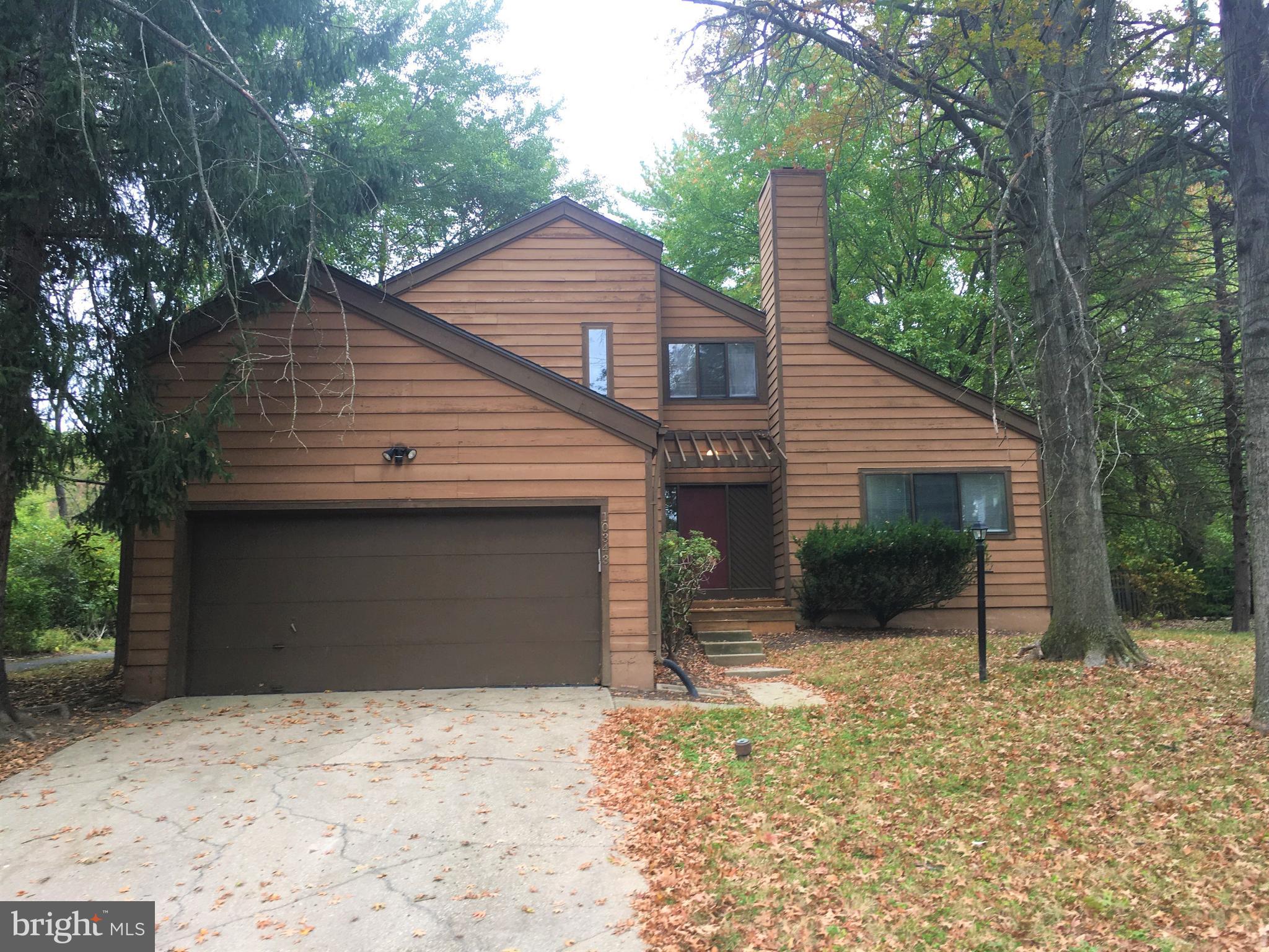 10343 Tailcoat Way Columbia, MD 21044 - Photo 21 of 21 a front view of a house with a yard and garage